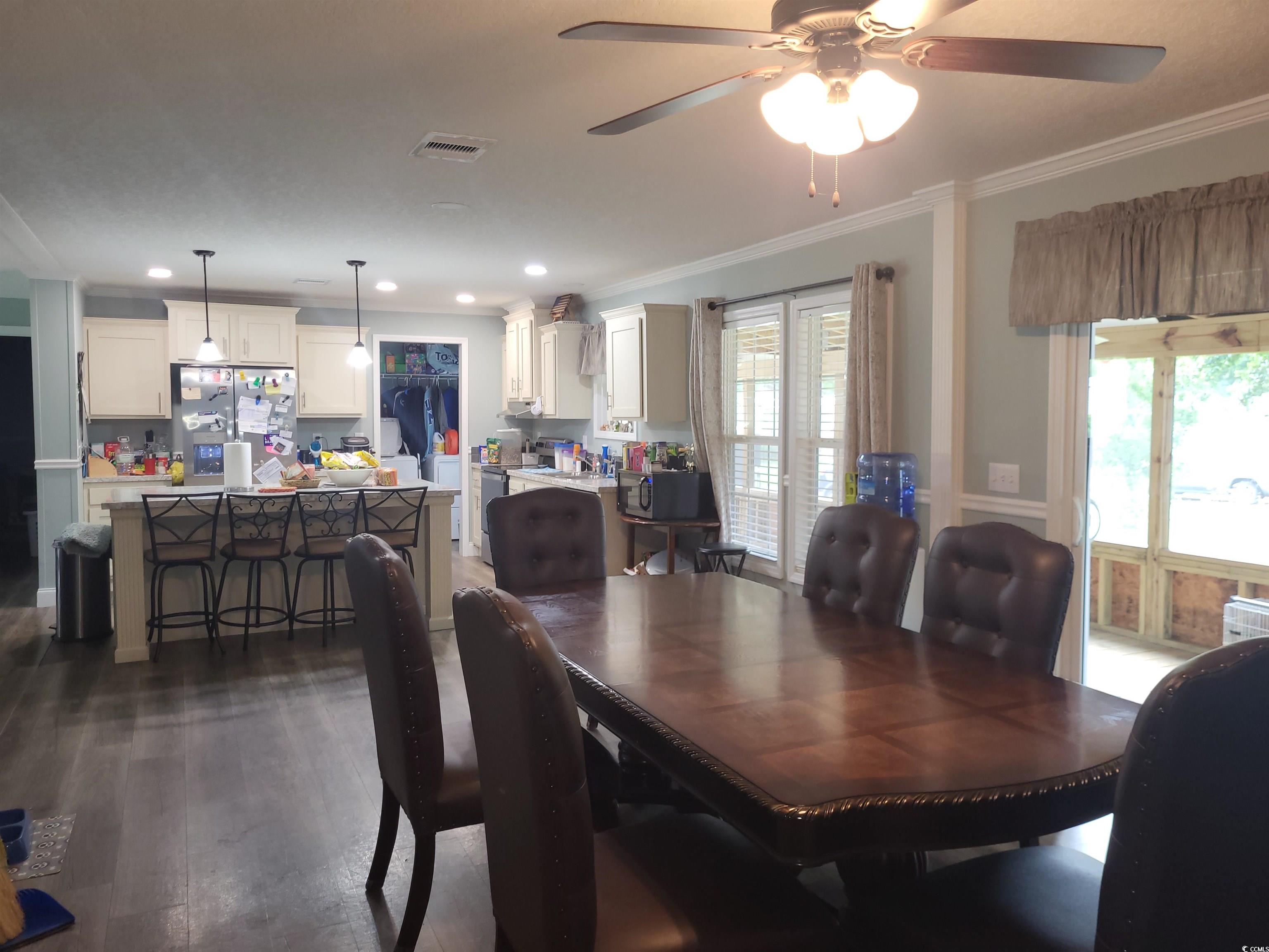 181 Offshore Drive Murrells Inlet, SC 29576 - Photo 9 of 28 Dining area with dark wood finished floors, a ceiling fan, crown molding, and recessed lighting