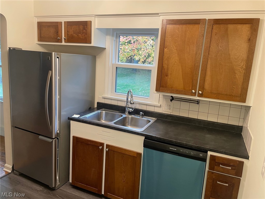 5972 Crossview Road Independence, OH 44131 - Photo 5 of 33 Kitchen featuring sink, tasteful backsplash, stainless steel appliances, and dark hardwood / wood-style floors