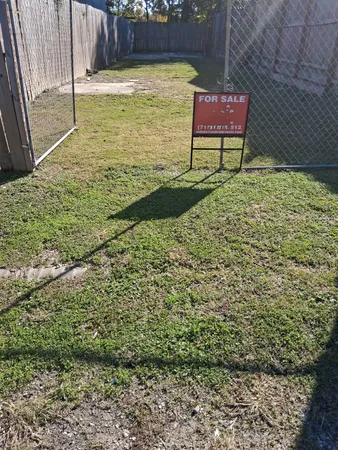 a wooden bench sitting in the middle of a yard