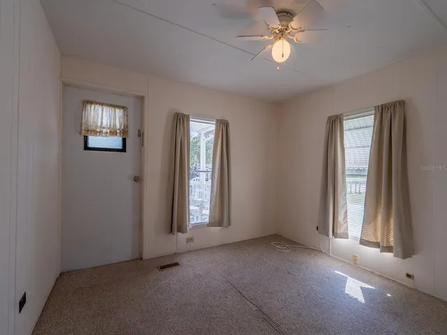 a kitchen with lot of cabinets and refrigerator