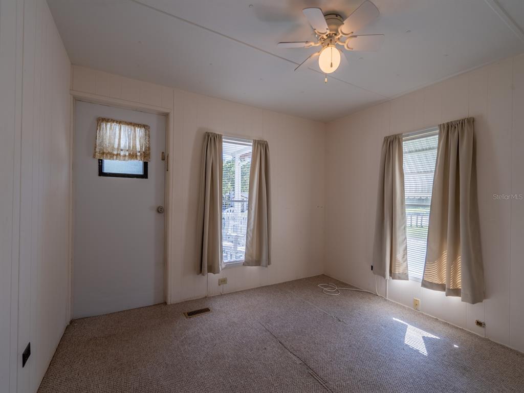 24797 Northeast 135th Street Salt Springs, FL 32134 - Photo 11 of 61 an empty room with windows and fan