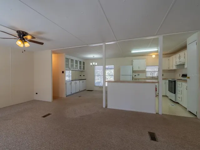 a kitchen with a refrigerator sink and cabinets
