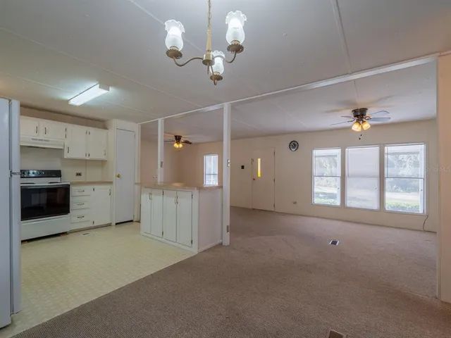 a view of a kitchen with a sink and cabinets