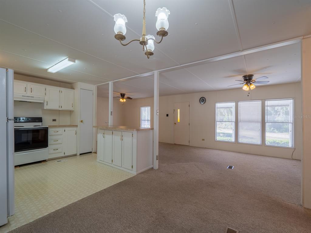 24797 Northeast 135th Street Salt Springs, FL 32134 - Photo 15 of 61 a view of a kitchen with a sink and a stove top oven