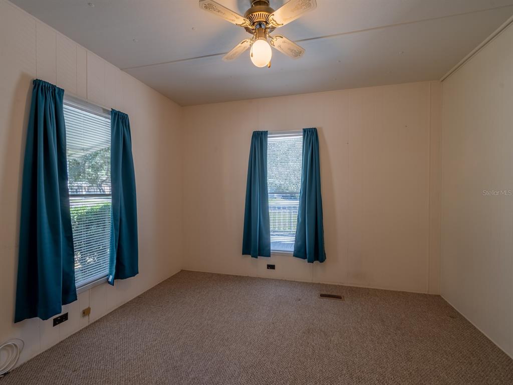 24797 Northeast 135th Street Salt Springs, FL 32134 - Photo 20 of 61 an empty room with windows and fan