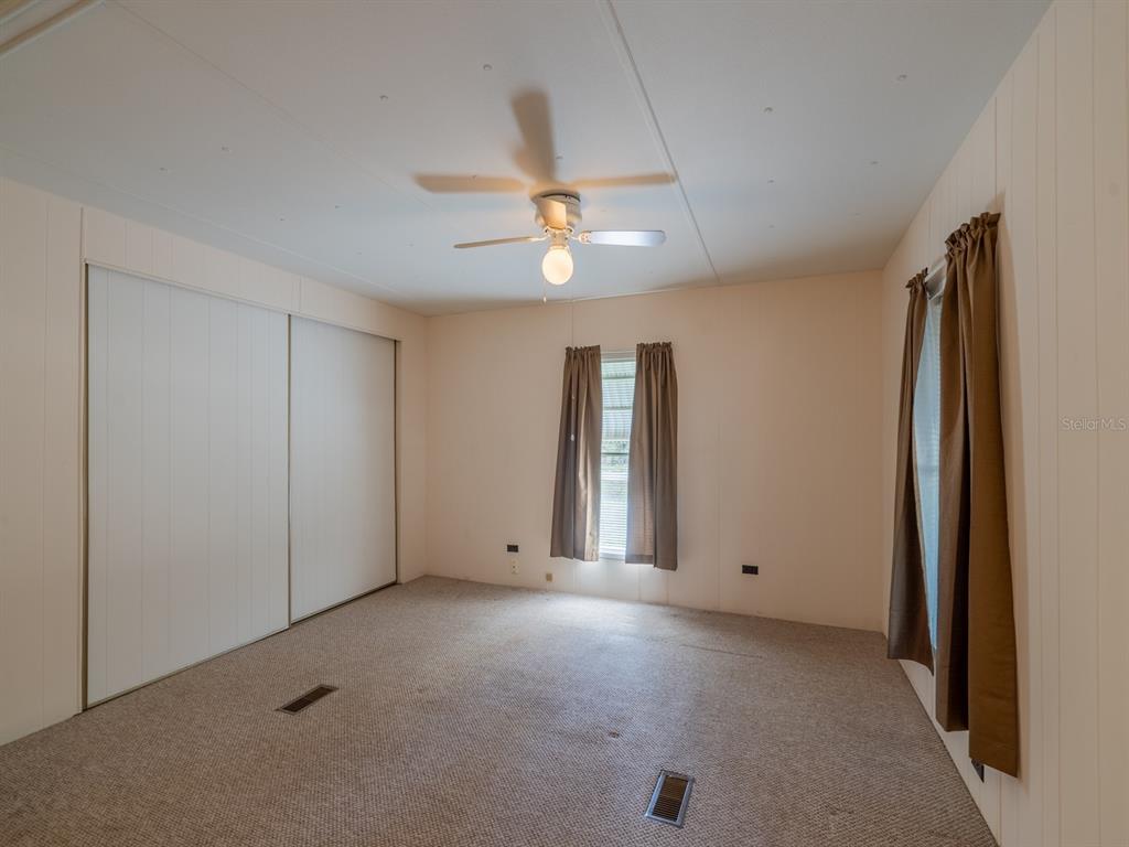 24797 Northeast 135th Street Salt Springs, FL 32134 - Photo 23 of 61 an empty room with ceiling fan and window
