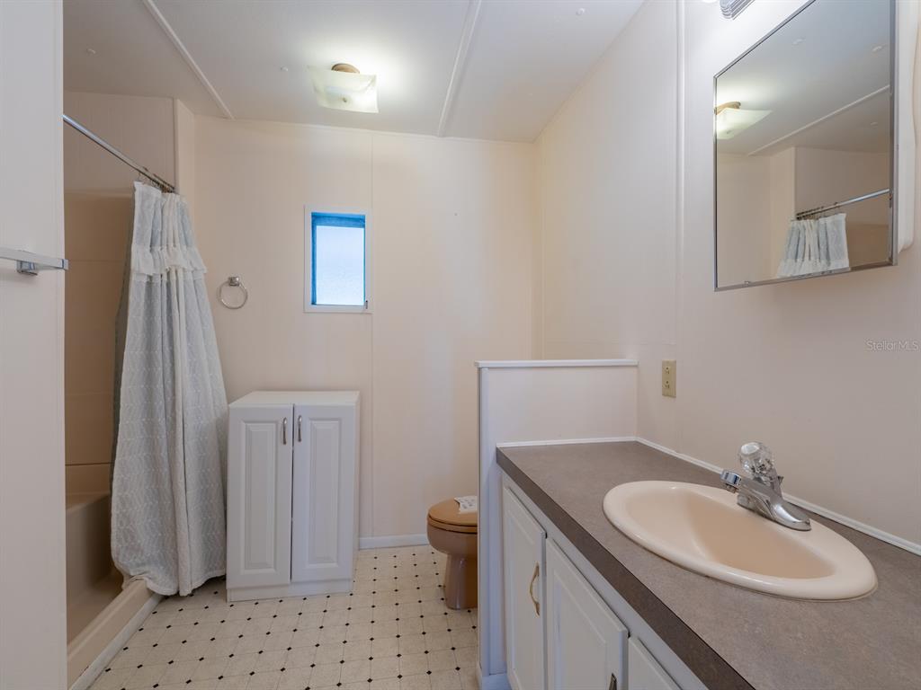 24797 Northeast 135th Street Salt Springs, FL 32134 - Photo 25 of 61 a bathroom with a granite countertop sink toilet and shower