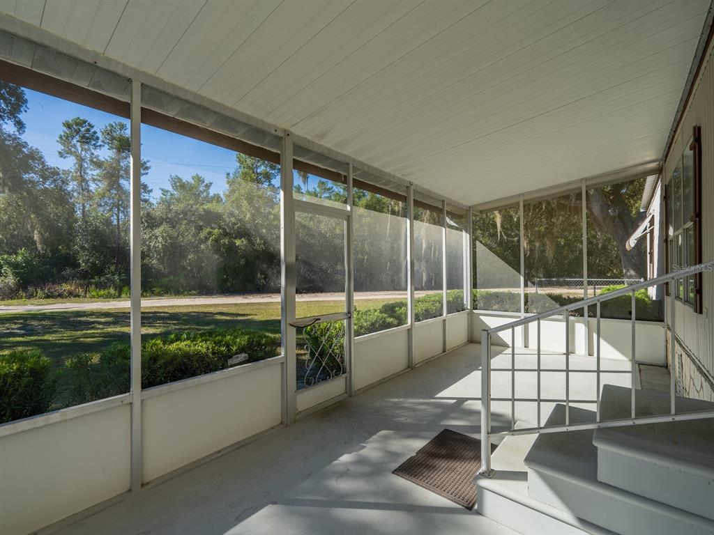 24797 Northeast 135th Street Salt Springs, FL 32134 - Photo 27 of 61 a view of a living room and floor to ceiling window