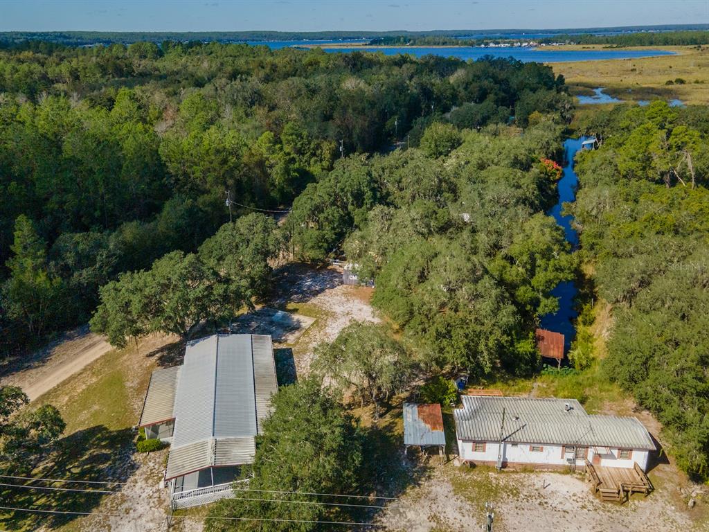 24797 Northeast 135th Street Salt Springs, FL 32134 - Photo 33 of 61 an aerial view of a house with a yard