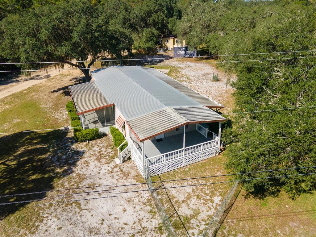 24797 Northeast 135th Street Salt Springs, FL 32134 - Photo 37 of 61 a view of a patio with chairs and a stove