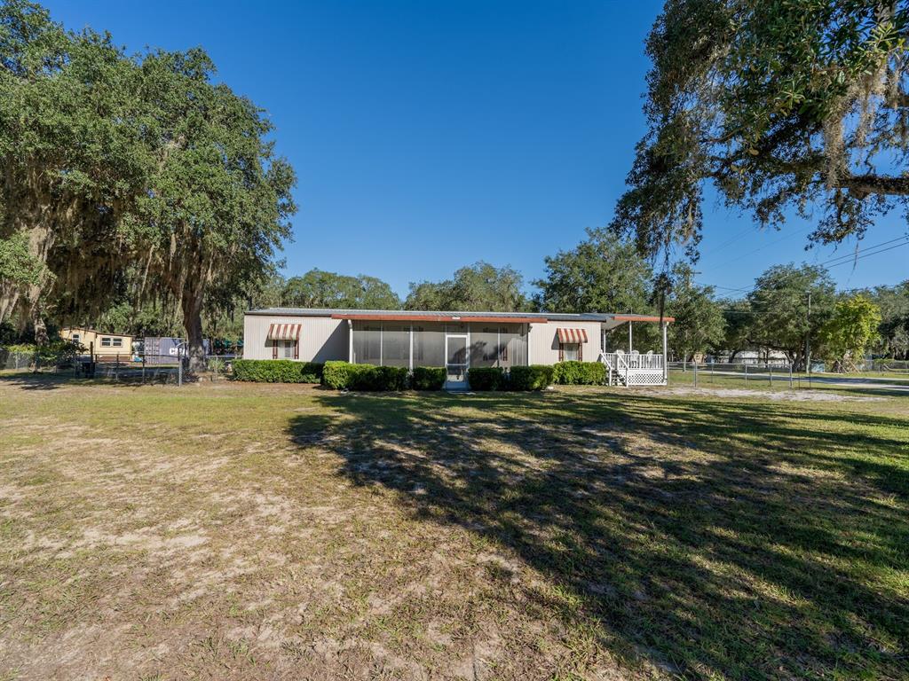 24797 Northeast 135th Street Salt Springs, FL 32134 - Photo 39 of 61 a view of a house with a yard