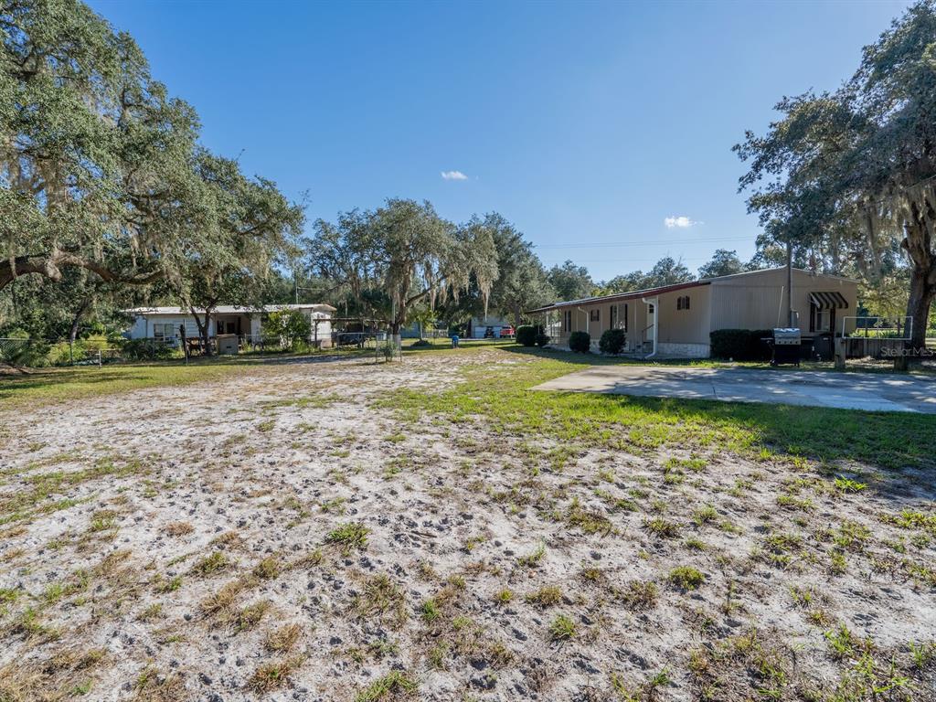 24797 Northeast 135th Street Salt Springs, FL 32134 - Photo 44 of 61 a swimming pool with outdoor seating and yard