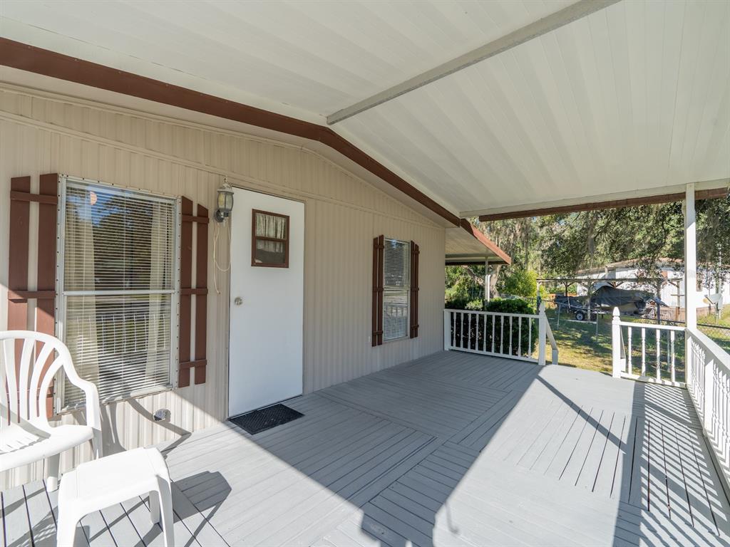 24797 Northeast 135th Street Salt Springs, FL 32134 - Photo 9 of 61 a balcony with furniture and a potted plant