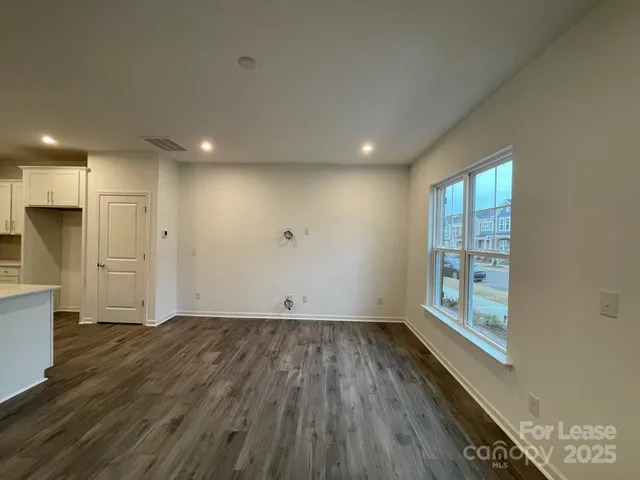 an empty room with wooden floor and a window