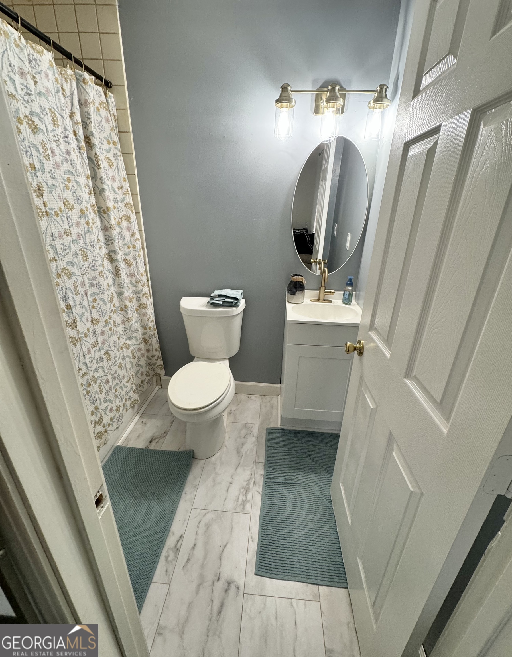 2009 Euclid Street Statham, GA 30666 - Photo 12 of 14 a view of a bathroom with toilet sink and mirror