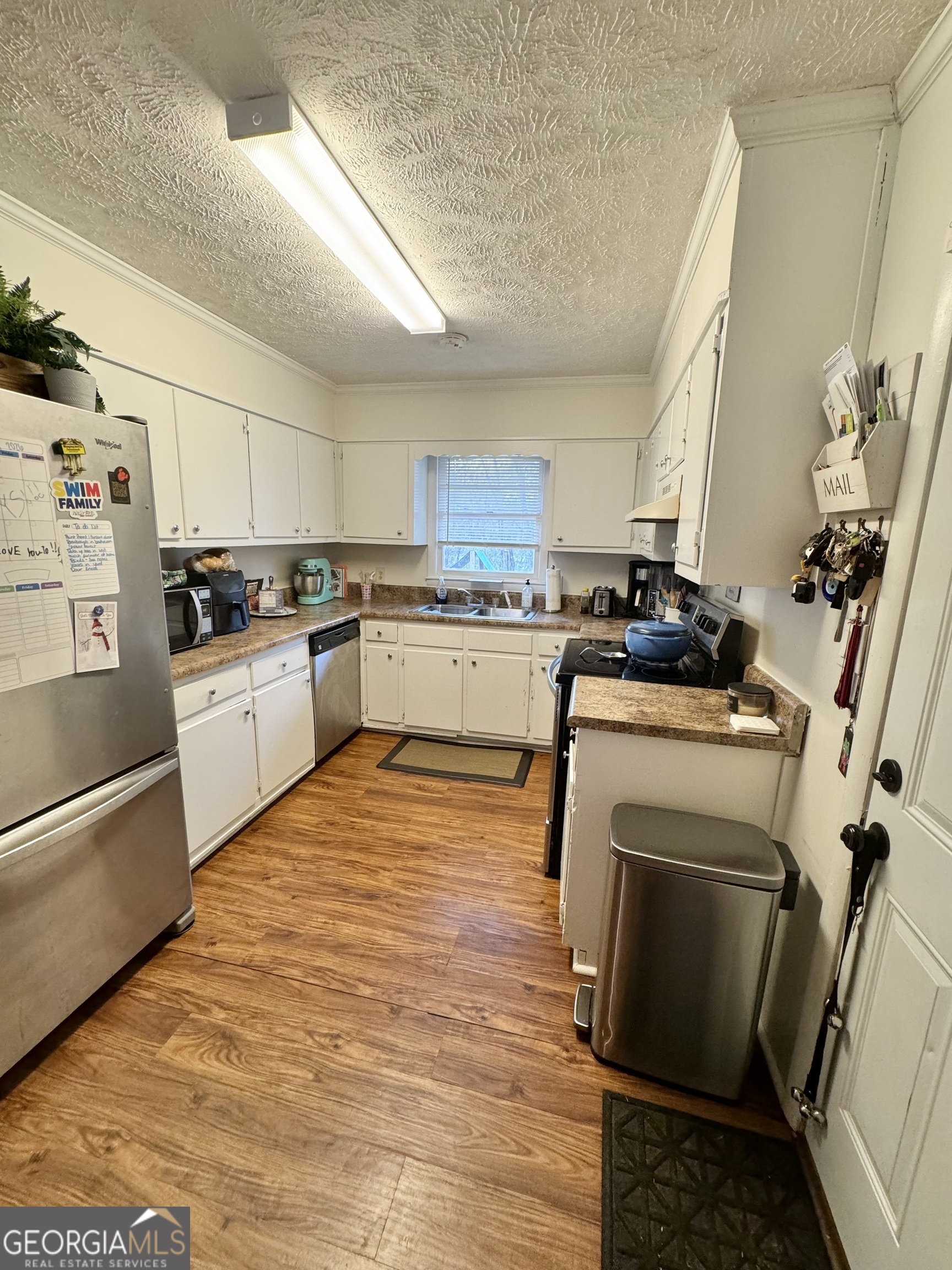 2009 Euclid Street Statham, GA 30666 - Photo 7 of 14 a kitchen with a sink appliances and cabinets