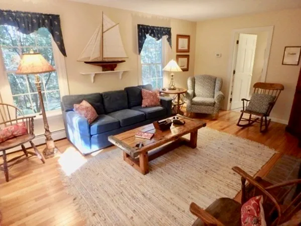 a living room with furniture and a lamp