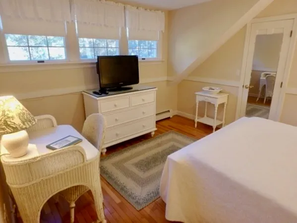 a bedroom with a bed and a night stand