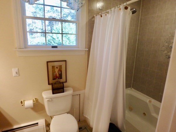 100 Connie's Way Tisbury, MA 02568 - Photo 27 of 34 a white toilet sitting next to a bathroom sink and tub