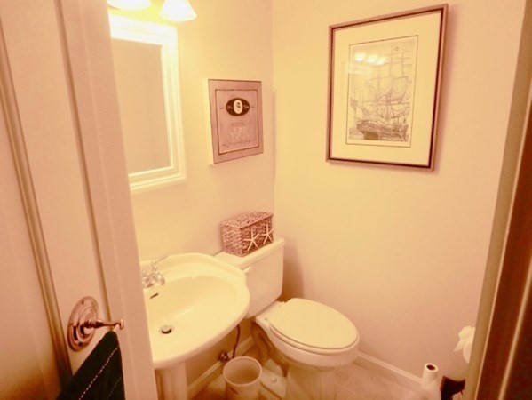 100 Connie's Way Tisbury, MA 02568 - Photo 29 of 34 a white toilet sitting next to a bathroom sink and vanity