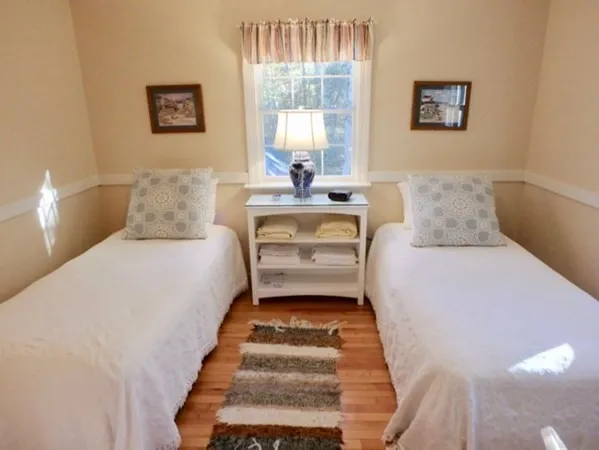 a kitchen with white cabinets and sink