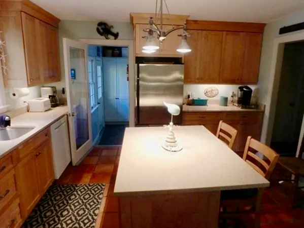 a kitchen with a refrigerator and a stove