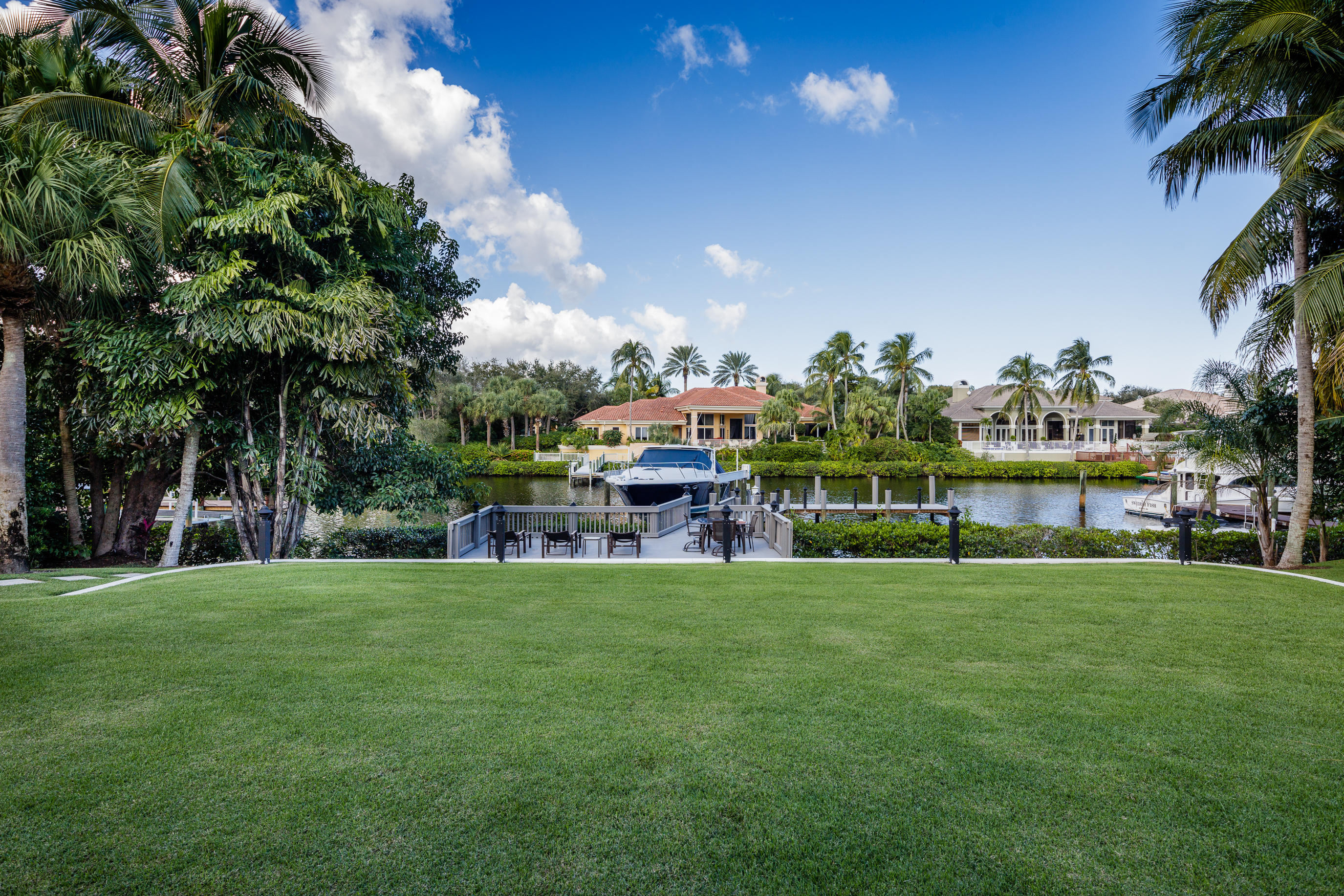 408 Mariner Drive Jupiter, FL 33477 - Photo 9 of 9 a view of a house with a big yard and palm trees