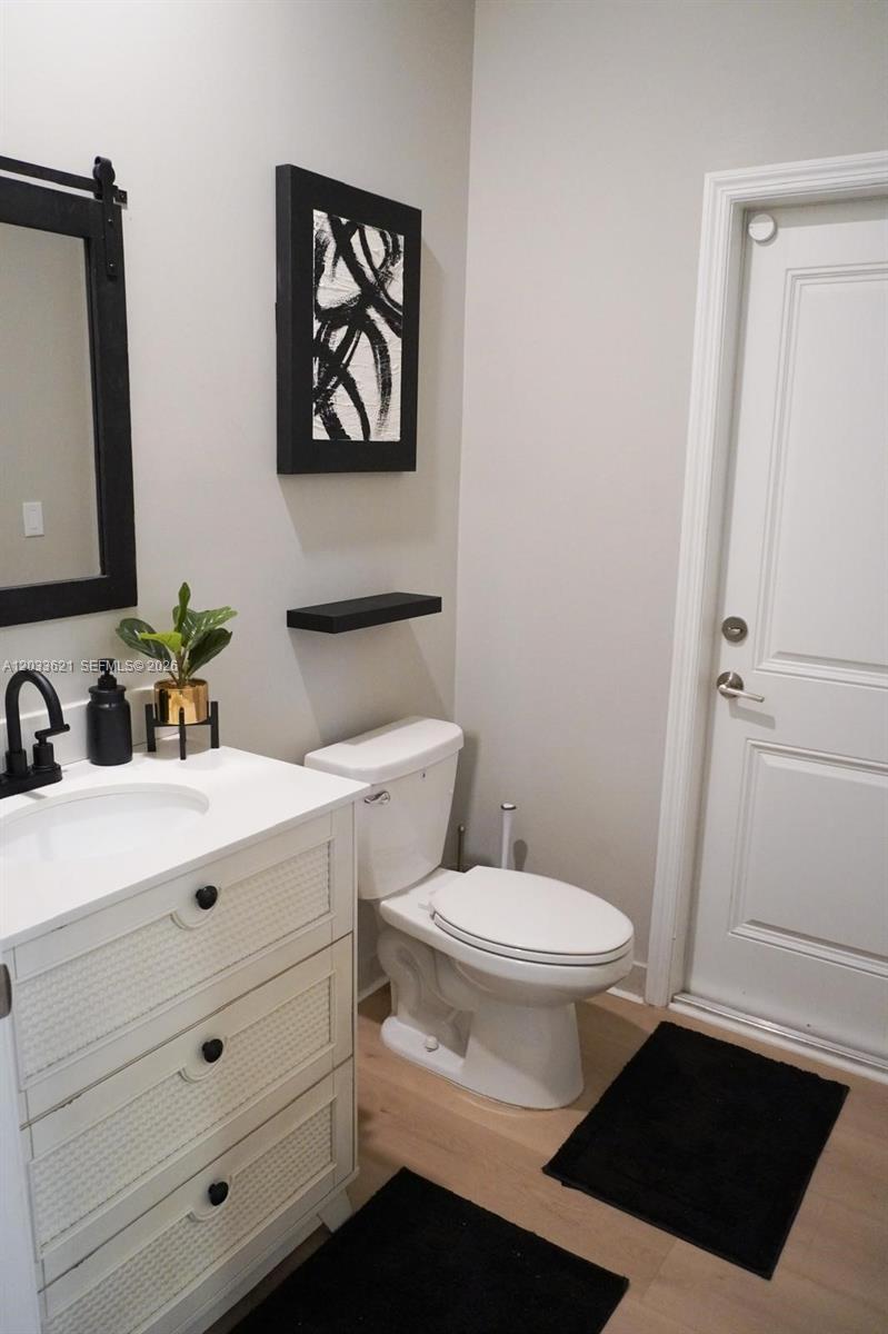 11942 Southwest 243rd Street Homestead, FL 33032 - Photo 12 of 50 a bathroom with a toilet a sink and mirror