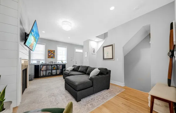 a living room with furniture and a fireplace