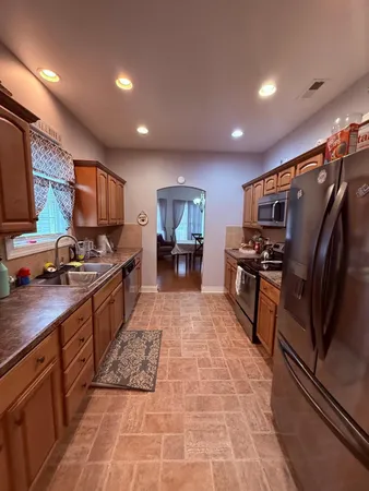 a large kitchen with stainless steel appliances lots of counter space and breakfast area