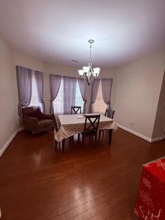 a view of a dining room with furniture and chandelier