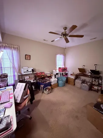 a view of a livingroom with furniture and a ceiling fan
