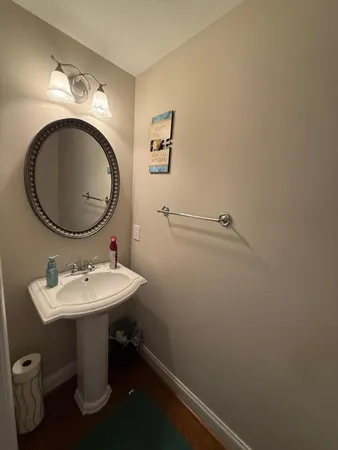 a white toilet sitting next to a bathroom sink