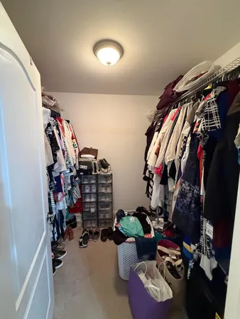 a living room with furniture a flat screen tv and a large window
