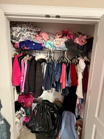 a bedroom with furniture and a large window