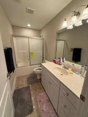 a spacious bedroom with a bed and a table in it