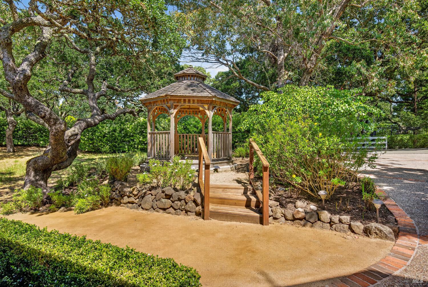 10 Lockton Lane Novato, CA 94945 - Photo 54 of 68 Garden gazebo tucked among mature trees, creating a charming outdoor destination near the front entry. Surrounded by mature trees: poplar, western redbud, blue oak, and magenta butterfly bushes.
