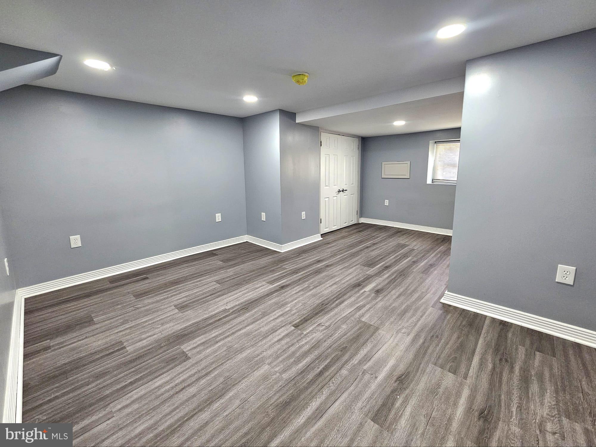 827 South 56th Street Philadelphia, PA 19143 - Photo 15 of 36 an empty room with wooden floor and windows