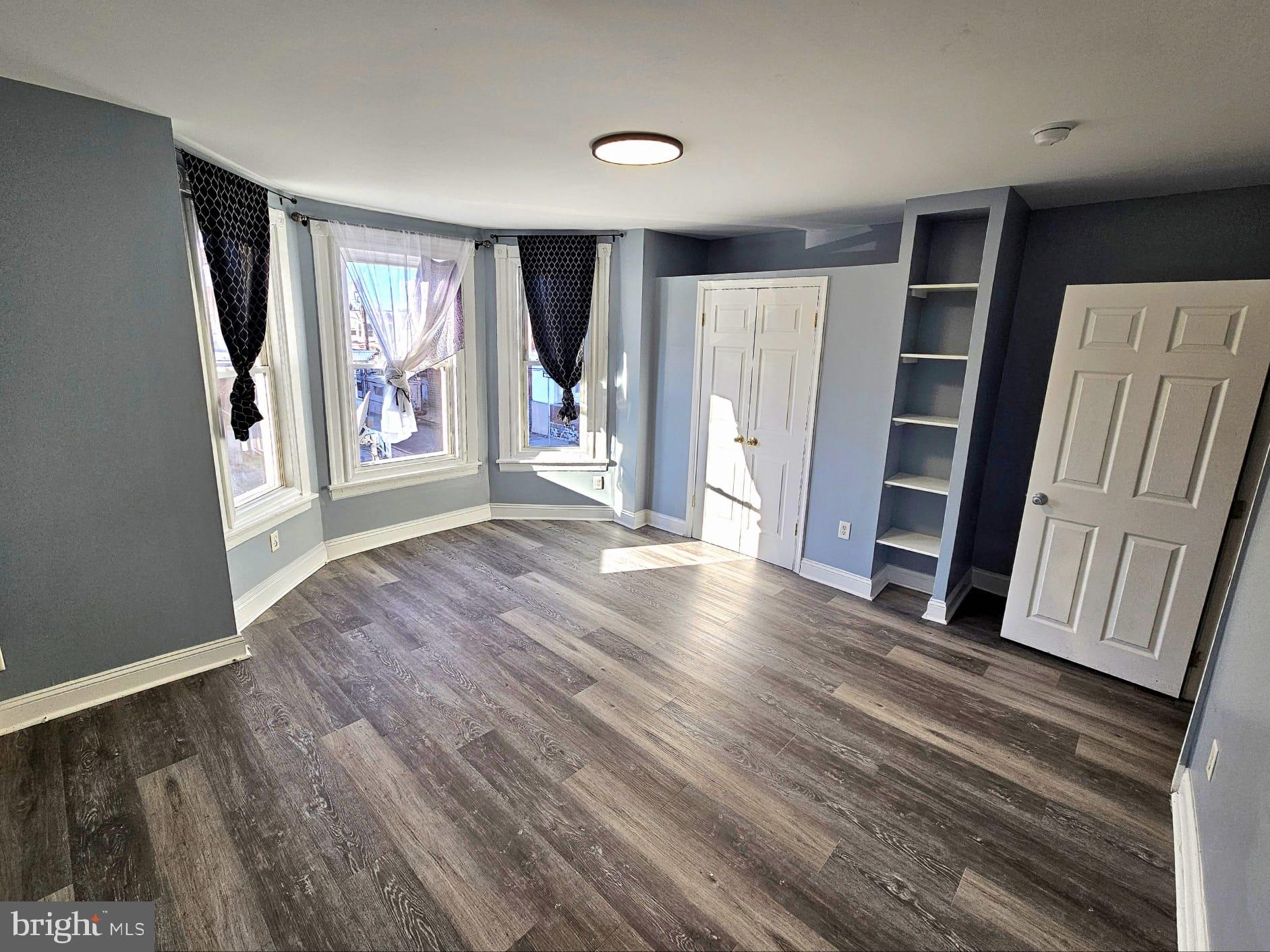 827 South 56th Street Philadelphia, PA 19143 - Photo 19 of 36 wooden floor in an empty room with a window