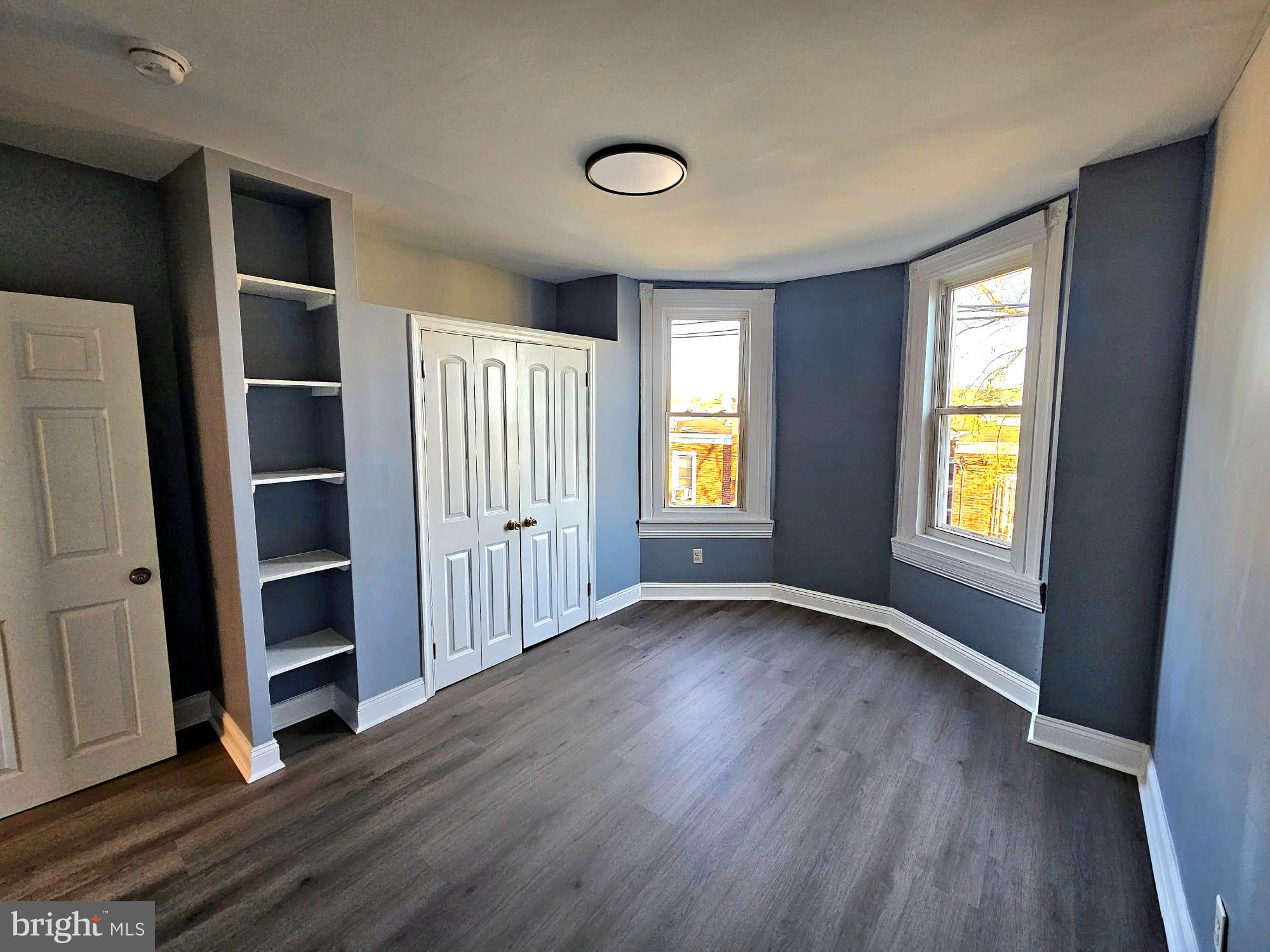 827 South 56th Street Philadelphia, PA 19143 - Photo 22 of 36 an empty room with wooden floor and windows