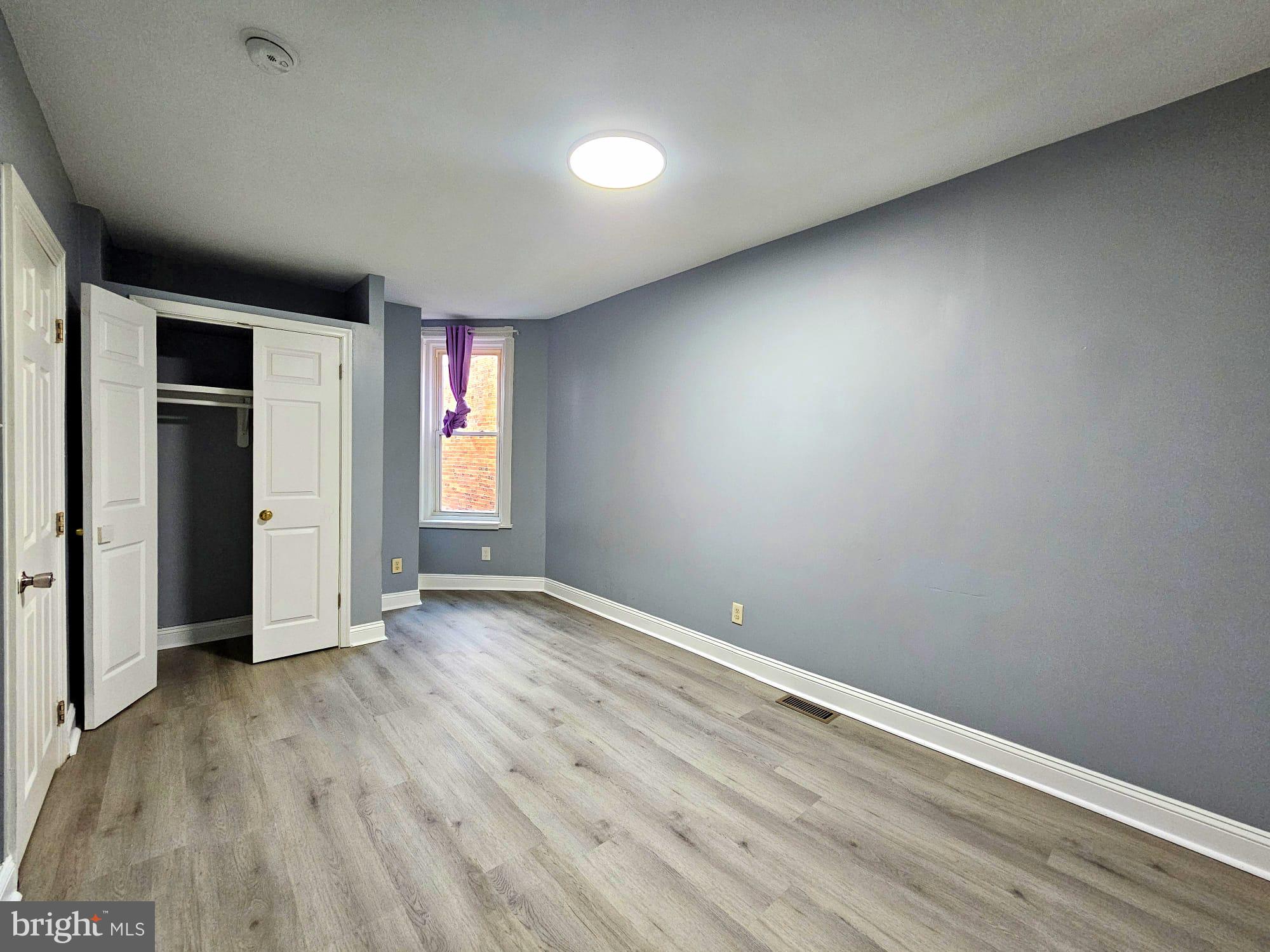 827 South 56th Street Philadelphia, PA 19143 - Photo 23 of 36 an empty room with wooden floor and windows