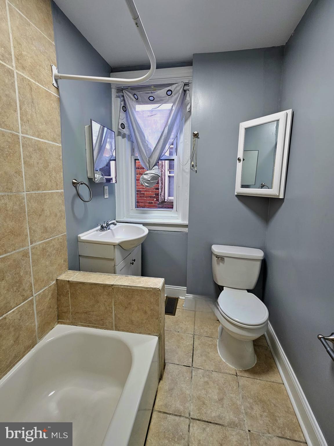 827 South 56th Street Philadelphia, PA 19143 - Photo 28 of 36 a bathroom with a toilet sink and mirror
