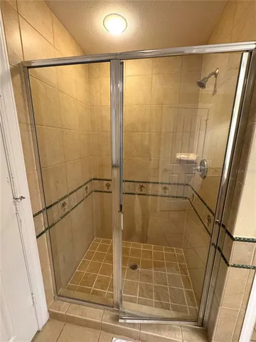 a bathroom with a glass shower door