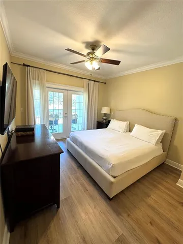 a bedroom with a large bed and a chandelier