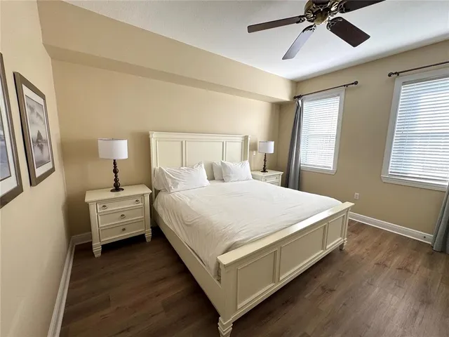 a large white bed sitting in a bedroom next to a window