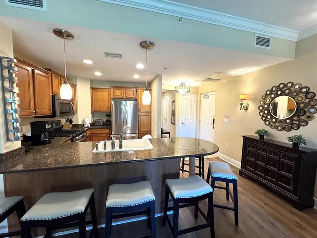 a kitchen with a dining table chairs and microwave