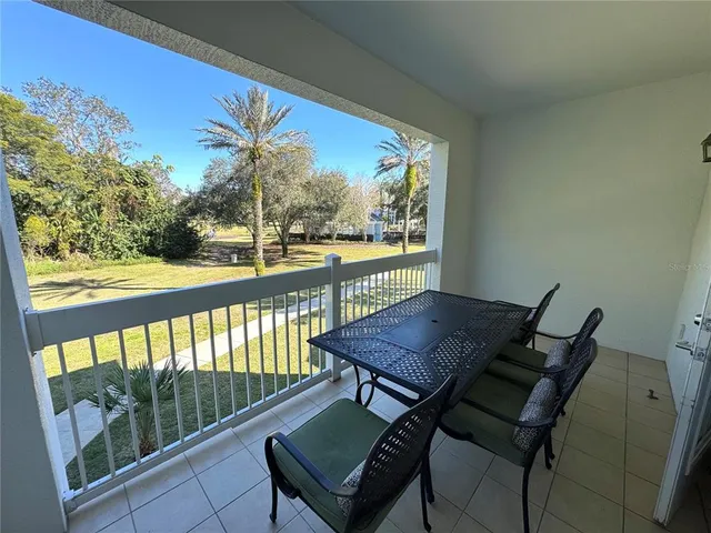 a view of a chairs and table in patio