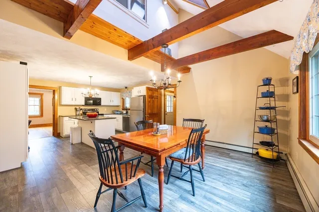 a dining room with a wooden table and chairs