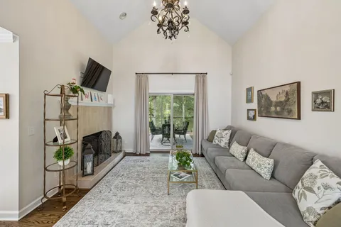 a kitchen with stainless steel appliances granite countertop a stove top oven a sink a dining table and chairs