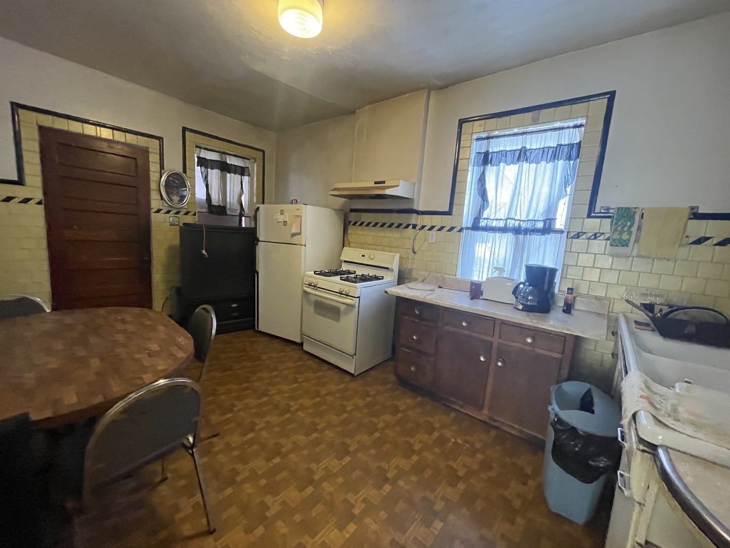 656 North Drake Avenue Chicago, IL 60624 - Photo 14 of 33 a kitchen with a refrigerator and a stove top oven